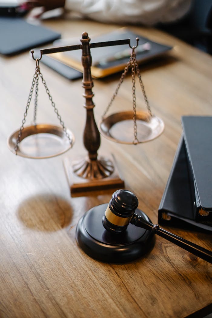about-us A striking image featuring a brass justice scale and gavel on a wooden desk, symbolizing law and justice.